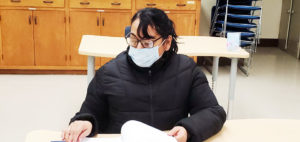 student at their desk with a covid mask