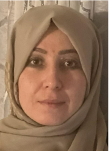 Contributing writer by Masooma Jowhary, wearing hijab, calmly faces the camera