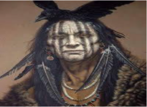 photo shows an Apache warrior in white face paint wearing crow feathers