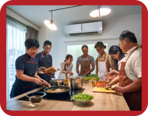 7 learners preparing food together in a kitchen