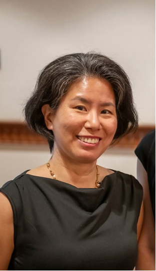 photograph of a stylish adult woman (PREP student EJ) facing camera and smiling